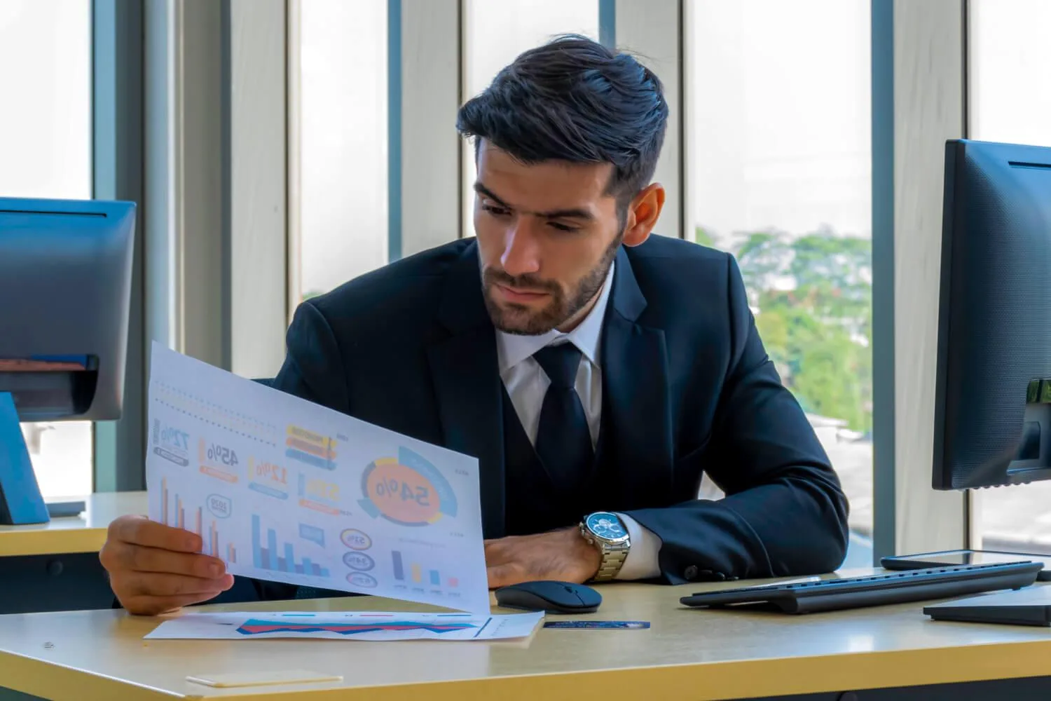 Analyst reviewing portfolio data and charts at a research desk